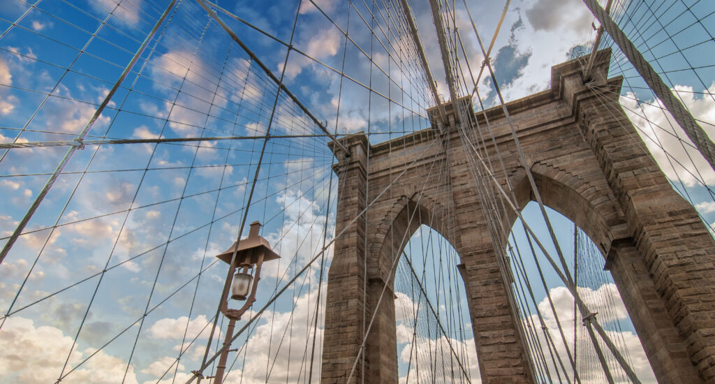 brooklyn bridge, new york city. upward view with beautiful sky colors.